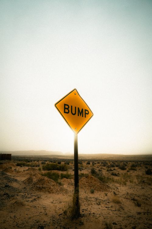 Free Yellow bump road sign amidst the vast desert landscape of Lake Powell, Arizona, USA. Stock Photo