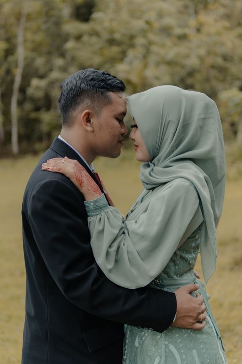 Free Intimate candid moment of a couple during a pre-wedding photoshoot in Pacitan, Indonesia. Stock Photo