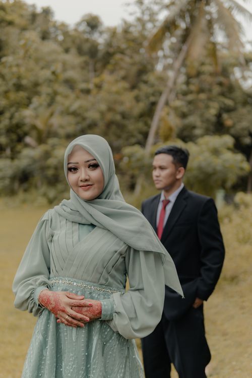 Free Outdoor pre-wedding photoshoot featuring an elegantly dressed couple in Pacitan, East Java. Stock Photo