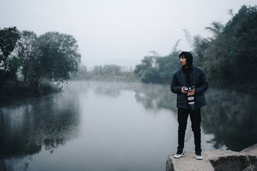 Photographer Standing by River
