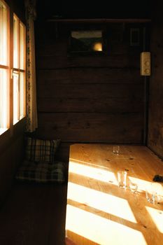 Warm sunlight casting on a wooden table in a cozy room in Sonntag, Vorarlberg.
