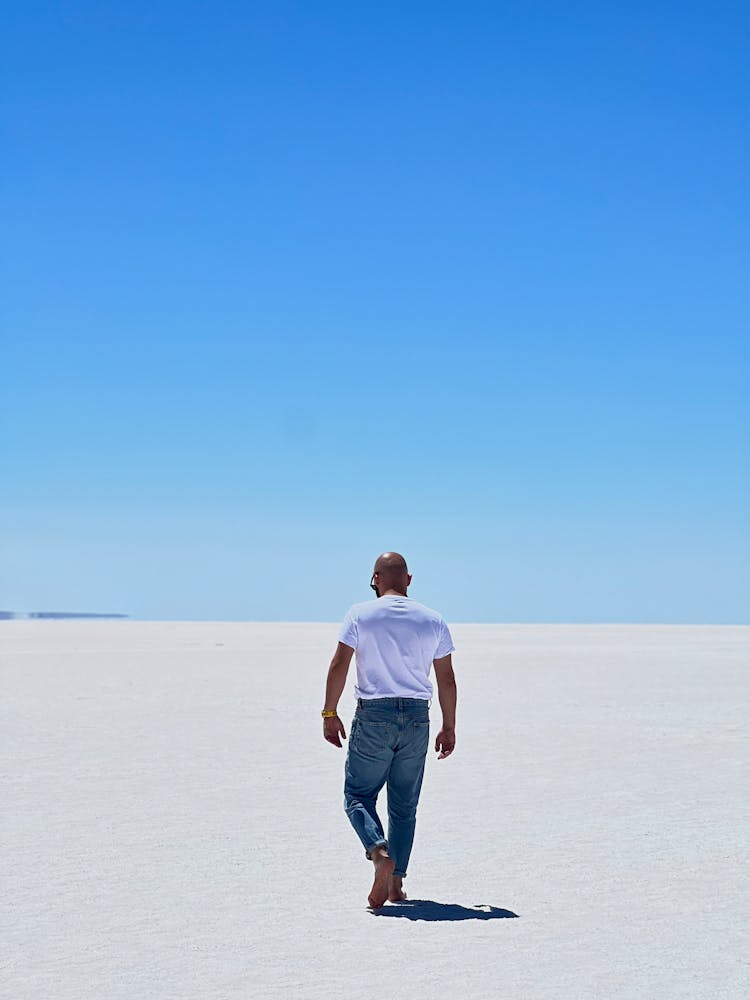 Barefoot Man Walking On Desert