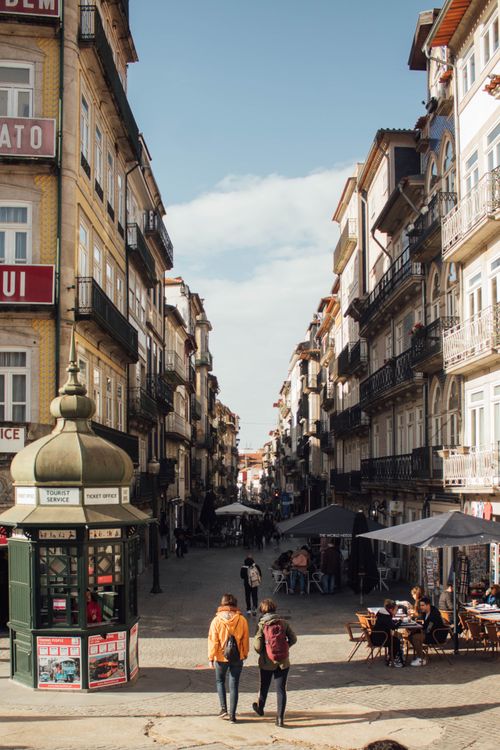 Free Picturesque street in Porto, Portugal, showcasing historic architecture and vibrant urban life. Stock Photo