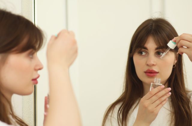 Woman applying skincare