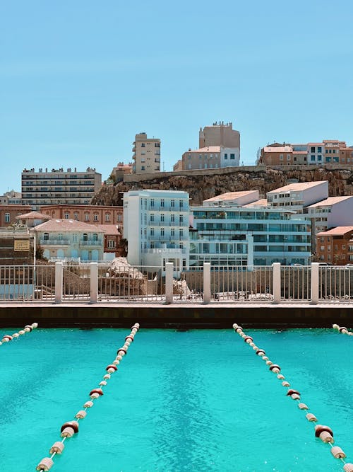 View of a Swimming Pool and Apartment Buildings in a Town 