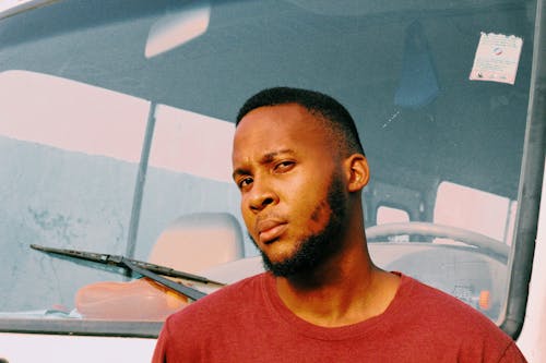 Bearded Man in Front of Vehicle