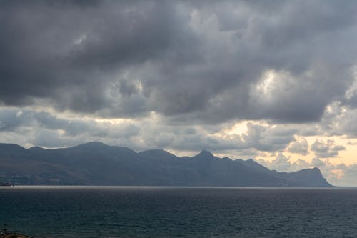 Clouds over Sea Coast with Hills