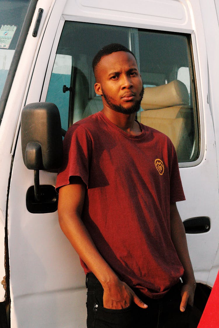 Man Standing By Car Door