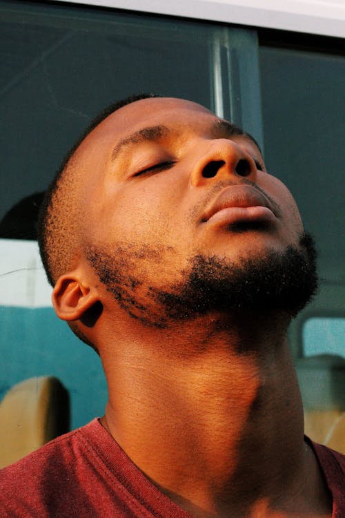 Young Man Standing with His Eyes Closed and Head Tilted Back 