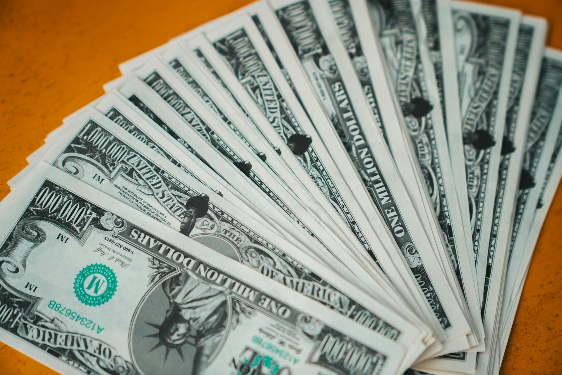 Closeup of novelty one million dollar bills laid out in a fan arrangement.