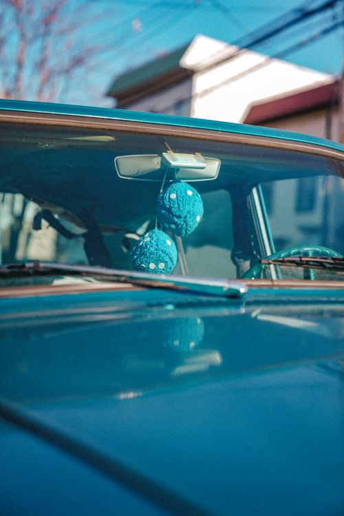 Free Close-up of a vintage car with hanging dice, captured on a sunny day in New York City. Stock Photo