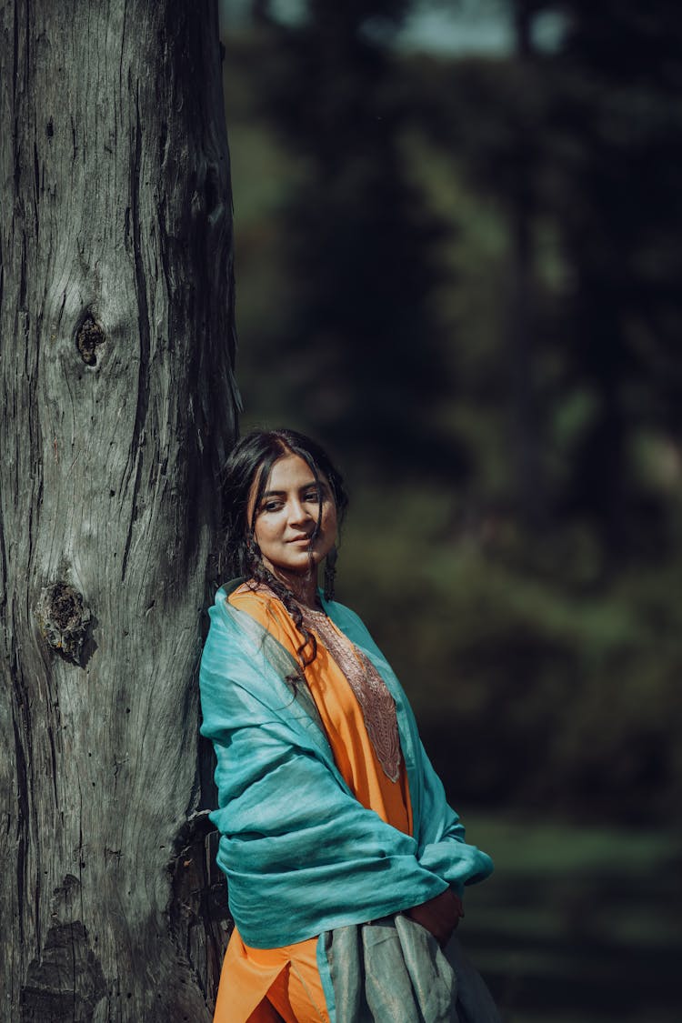 Brunette Woman Posing In Orange Dress And Turquoise Shawl