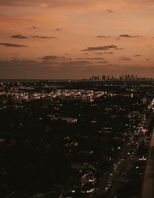 Free Aerial view of Miami skyline during sunset with visible city traffic and urban landscape. Stock Photo