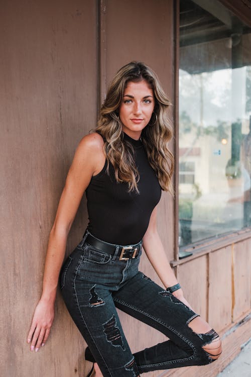 Blonde Woman Standing by Wall