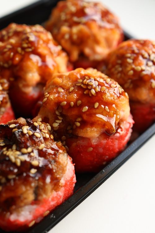 Free Tasty meatballs glazed with sauce and sprinkled with sesame seeds on a plate. Stock Photo