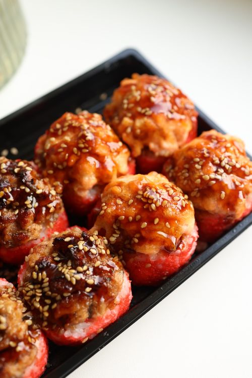 Free Mouthwatering meatballs topped with sesame seeds, perfect for food photography enthusiasts. Stock Photo