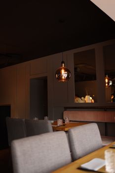 Warm and inviting restaurant interior featuring stylish pendant lighting and comfortable seating.