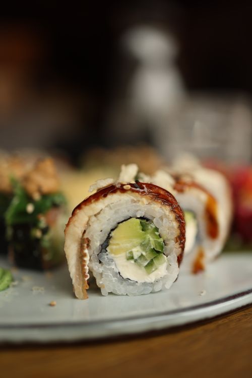 Free Close-up of fresh sushi rolls with avocado and eel, perfect for restaurant menus. Stock Photo