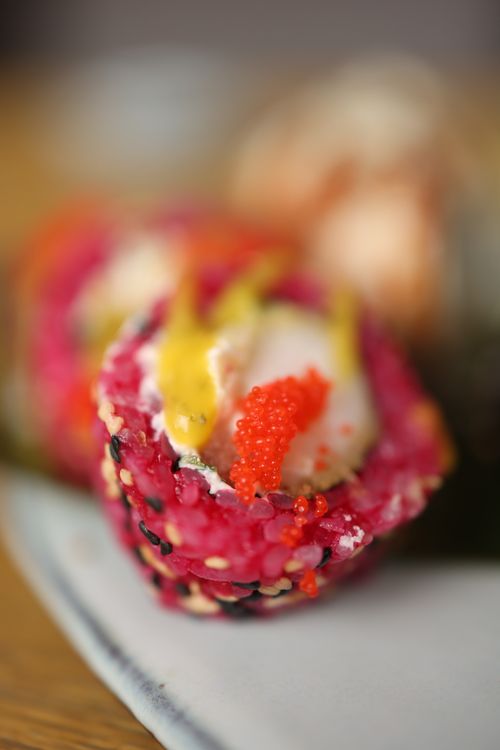 Free Colorful sushi roll with vivid caviar, captured in a detailed close-up. Perfect food photography. Stock Photo