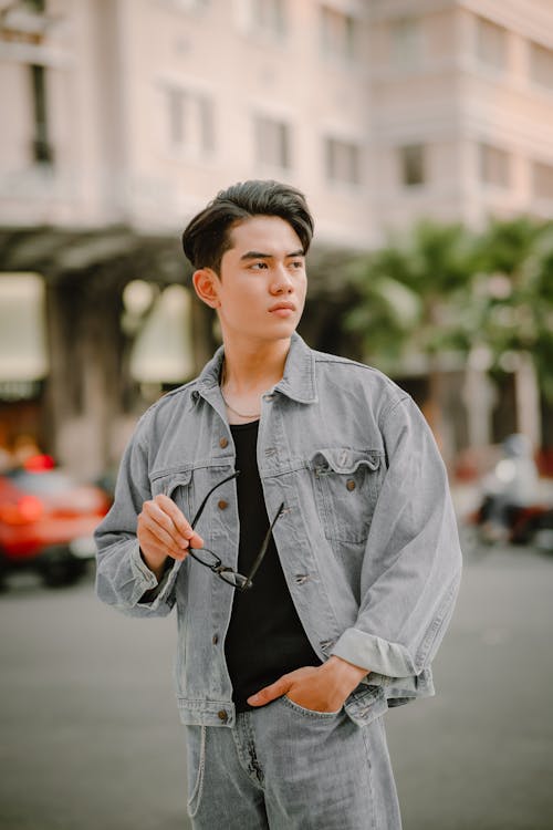 Man in Jean Jacket Standing on Street