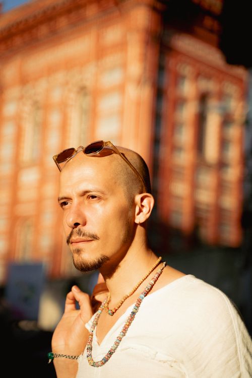 Free Bald man wearing sunglasses and necklaces in front of a historic building in Istanbul. Stock Photo