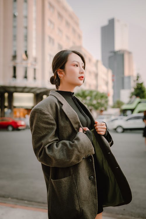 Woman in Jacket Standing near Street