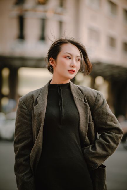 Portrait of a stylish businesswoman in an urban setting wearing an elegant jacket.