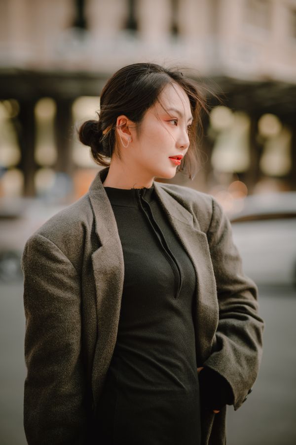 Woman in tweed blazer over silk camisole