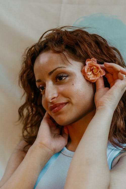 Woman Holding Flower in Hair