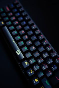 Backlit gaming keyboard with colorful keys on a black background, ideal for tech enthusiasts.