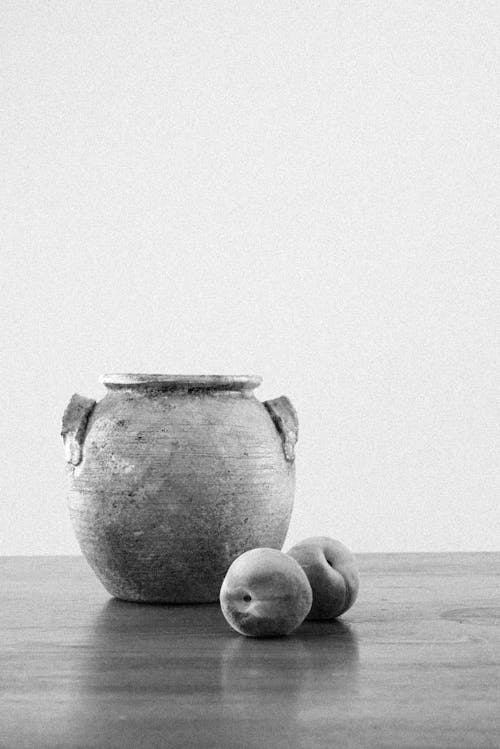 Clay Pot with Broken Handle and Peaches on Table