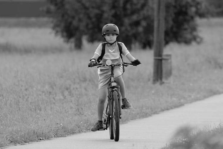 Boy Riding Bike With Helmet