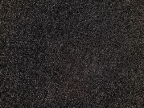 Close-up of a black textured surface, perfect for abstract backgrounds or designs.