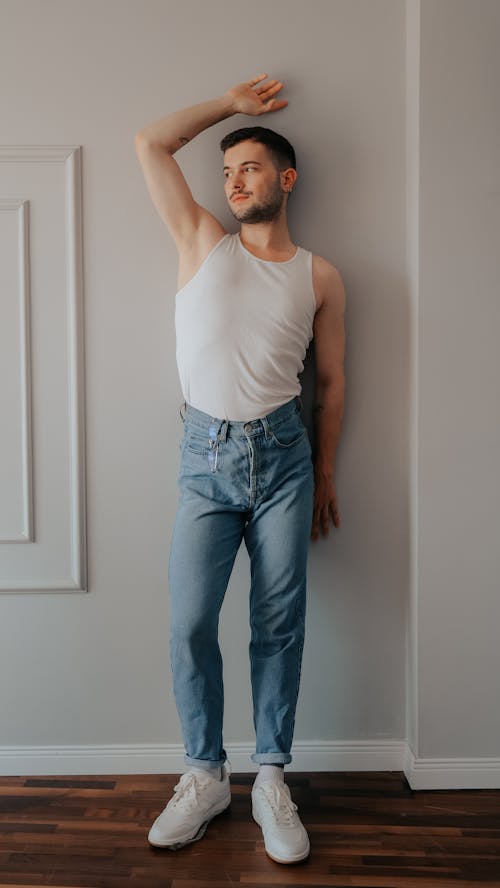 Young Man in a Casual Outfit Posing in a Modern Interior