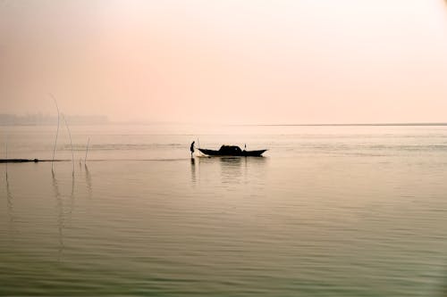 Silhouetted Boat on the Sea at Sunset 