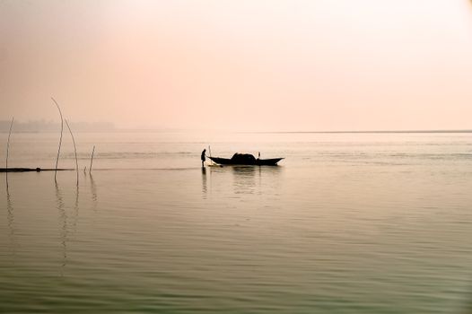 Silhouetted Boat on the Sea at Sunset 