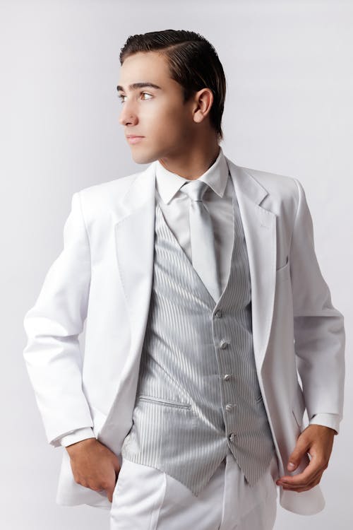 Young Man in a White Suit Posing in Studio 