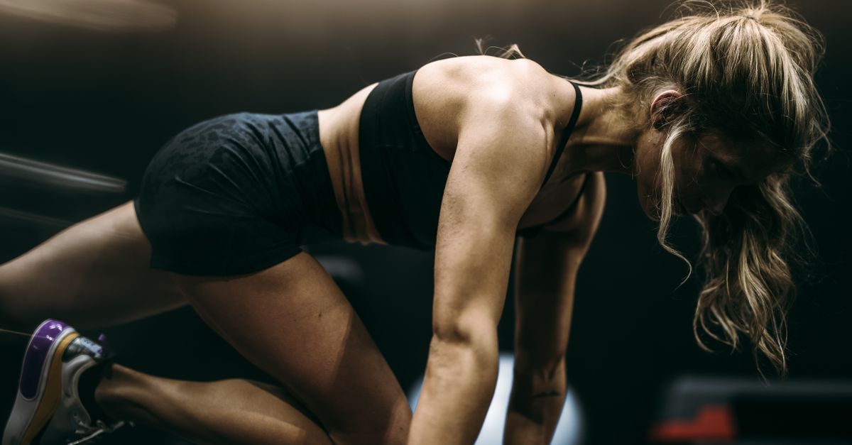 Focused female athlete in active pose working out at a gym in dynamic lighting. - Evidence evidence guide for citrulline exercise performance randomized trial