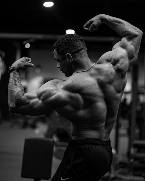 A Muscular Man Flexing His Muscles at the Gym 