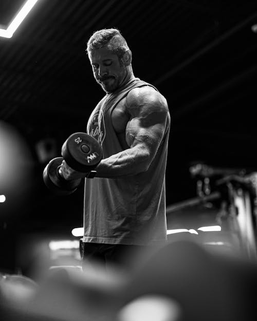 A Muscular Man Exercising at the Gym 