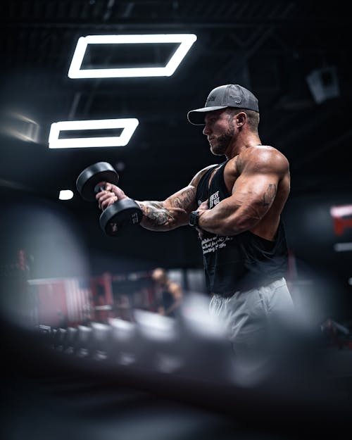 A Muscular Man Exercising at the Gym 