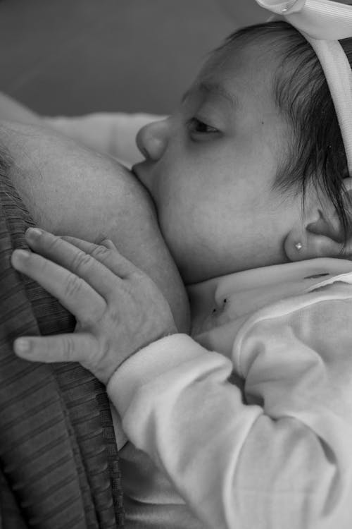 Newborn Baby Sucking on Mother Breast