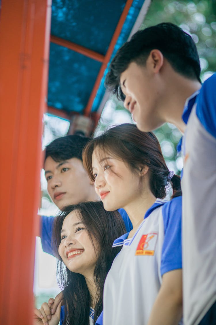 Group Of Teenager Students Posing In Matching T-shirts