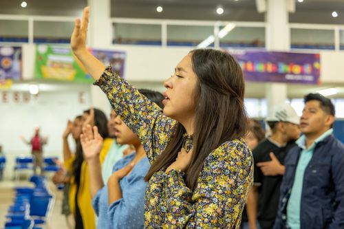 Free A diverse group of adults singing passionately indoors at a public event. Stock Photo