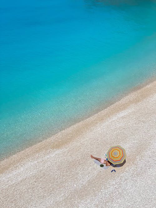 A Person Lying Alone on an Idyllic Beach