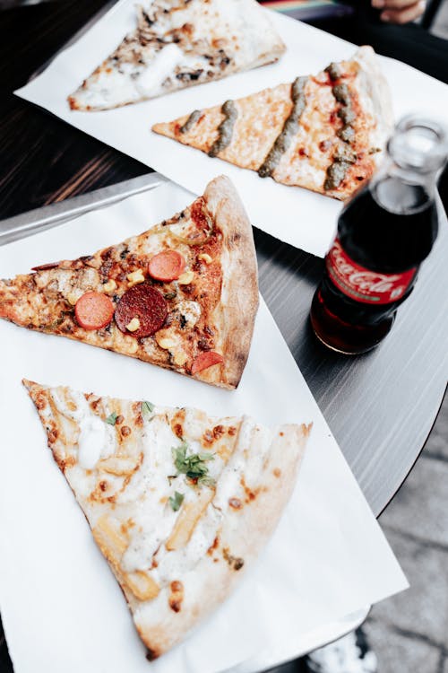 Free Slices of Pizza and a Bottle of Coca-Cola  Stock Photo