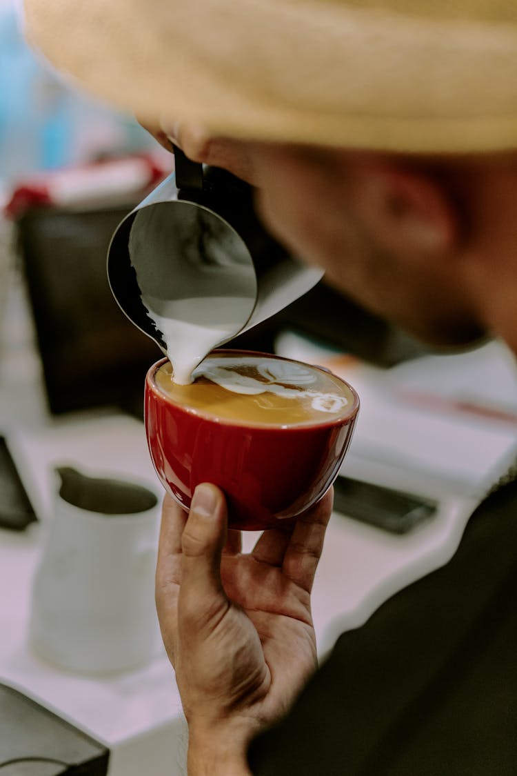 Barista Drawing With Textured Milk On Coffee