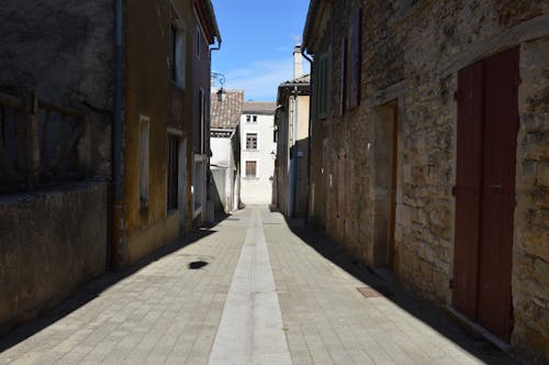 A Narrow Alley between Stone Buildings in a Town 