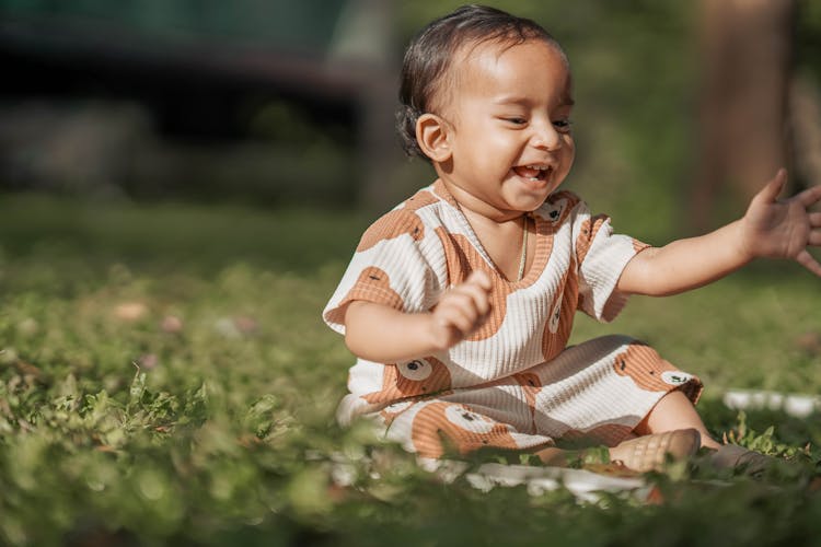 Toddler Sitting On The Grass