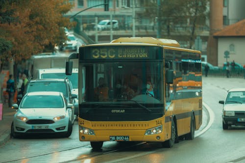 Yellow Bus Running on Wet Street